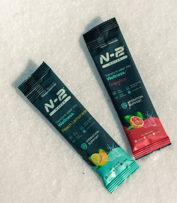 Two N-2 mineral hydration sticks resting in fresh snow