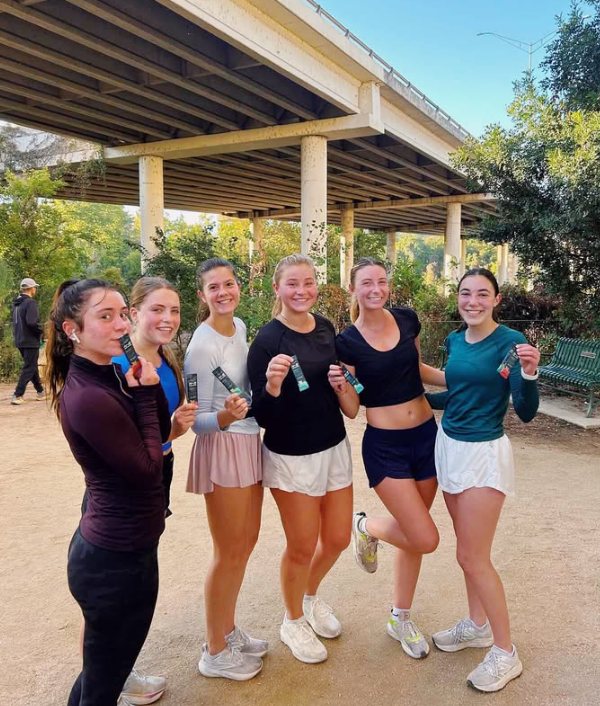 Run club members holding N-2 sticks after a group run